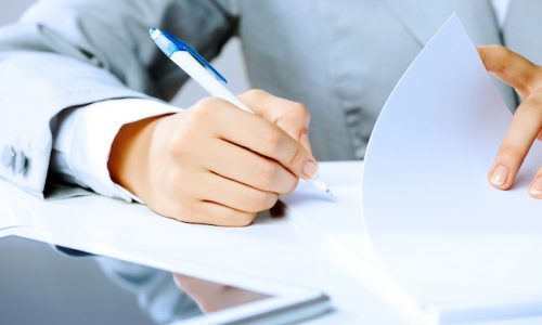 Close up image of businesswoman hands signing documents