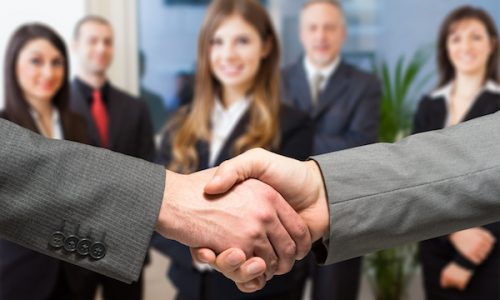 Business people shaking their hands in an office