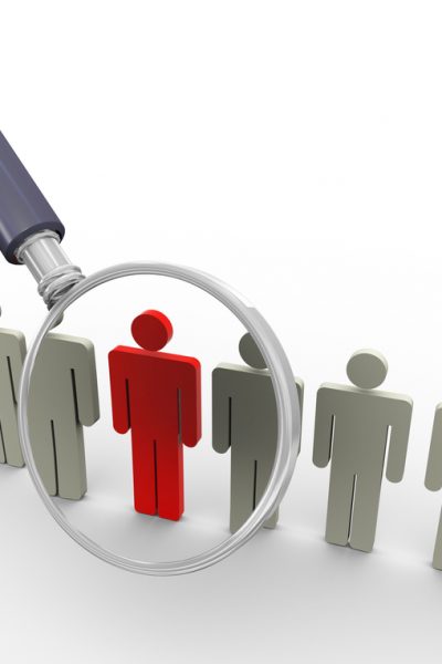 3d magnifying glass hovers over unique red man. Concept of searching people or employee