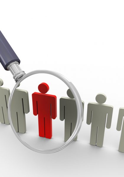 3d magnifying glass hovers over unique red man. Concept of searching people or employee